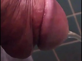 Solo Japanese boy with big head enjoys urinating.