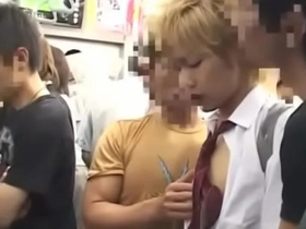 A young Japanese man gets a hand job on a train.