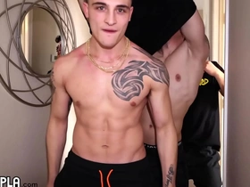 Muscular men with tattoos have sex on the set of a fitness video.