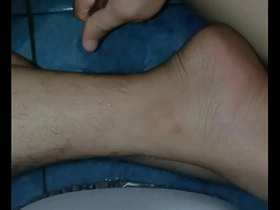 A solo boy gives a massage with oil to himself.