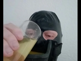 Gay BDSM gay piss drinking with a latex hood and urinal gag