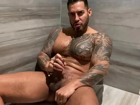 Muscular daddy with tattoos and nipple rings in a steamy shower experience.