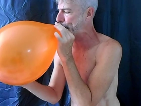 Gay DILF Richard Lennox has a balloon fetish and masturbates while playing with them.
