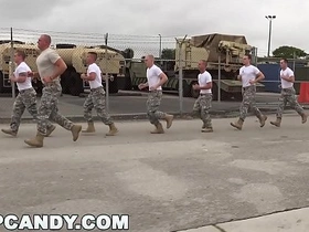 Muscular men in uniform have a group sex with an unknown partner in a gay orgy.