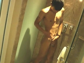 Young Asian boy washing up in the shower.
