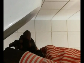 Public restroom urinal scene with a black gay man masturbating.