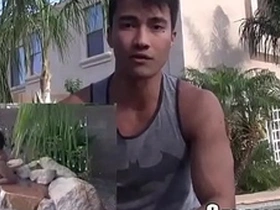 Muscular Asian man masturbating on camera.