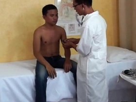 Young Asian boy gets anal stimulation from doctor after the medical examination.