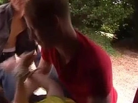 Young AJ and Mark spit roast cute twink Cory in outdoor group sex scene